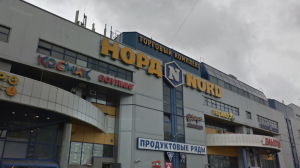 Окровавленную девушку и разбитую вывеску обступили прохожие у ТЦ «Норд»